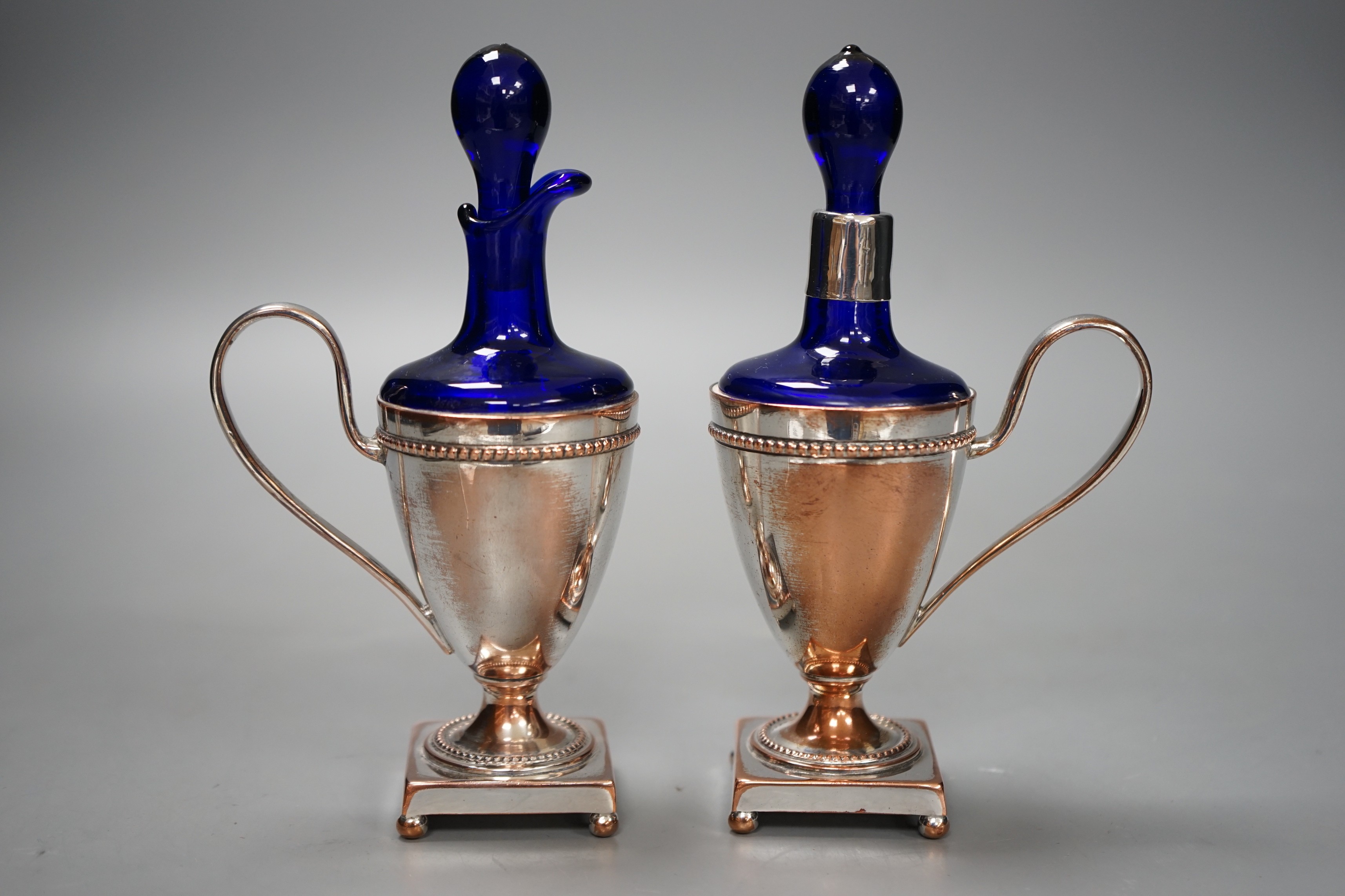 A pair of plate mounted blue glass scents, 16.5cm tall